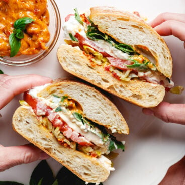 Burrata Sandwich with hands.