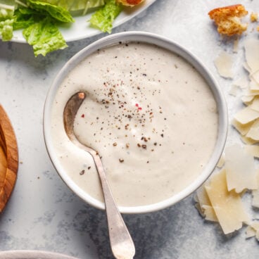 Caesar Dressing in bowl with spoon.